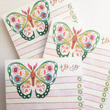 In the gardens of Wildflower Woods, a butterfly drifts from bloom to bloom, wings patterned with flowers gathered along the way. This notepad brings that light, floral moment to your desk, making everyday lists feel a little more inviting.

Designed to be practical without feeling busy, this notepad offers a simple, cheerful way to keep track of daily to-do lists and planning.