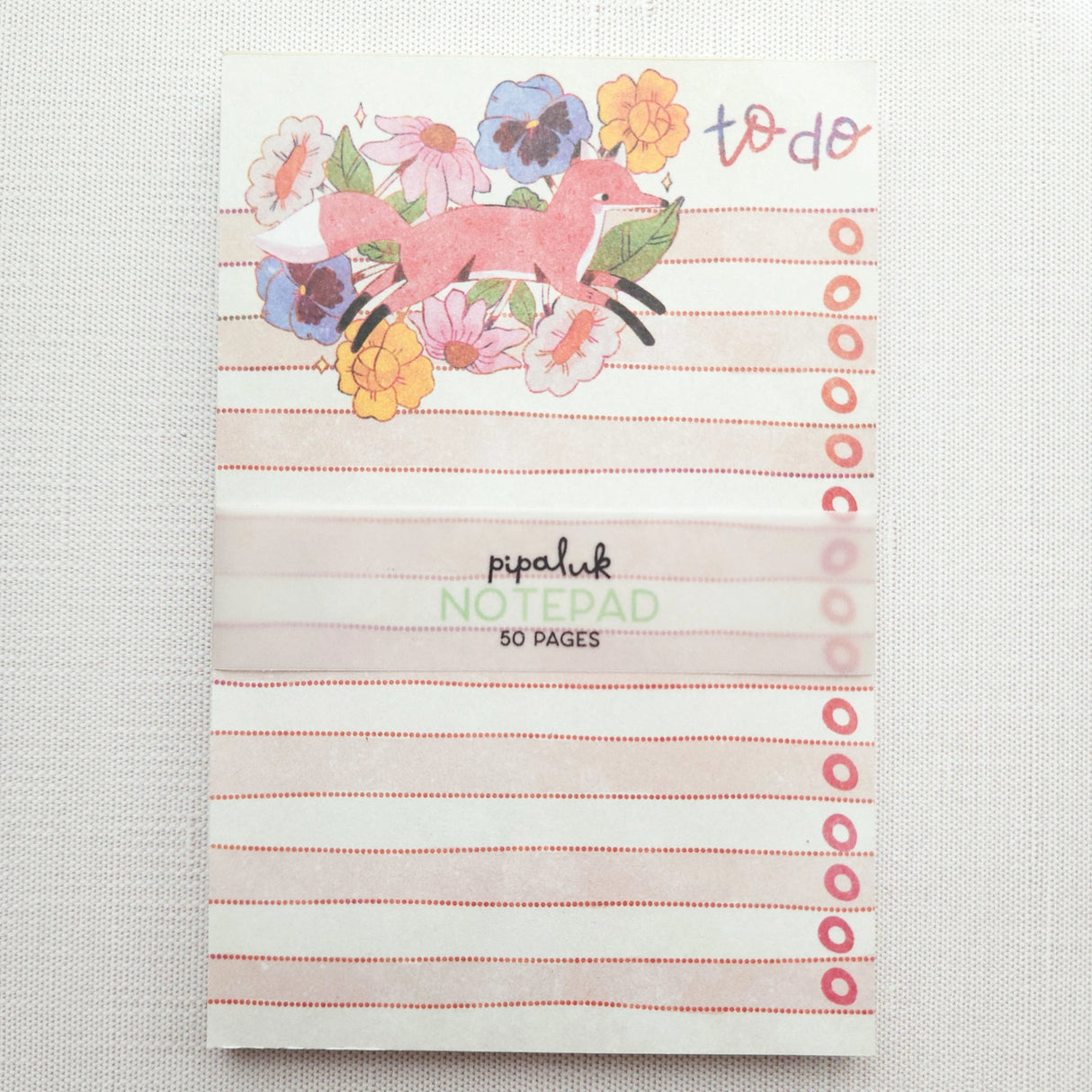 In a quiet clearing of Wildflower Woods, a fox moves through blooming flowers, petals lifting gently as he passes beneath open sky. This notepad brings that playful, woodland moment to your desk, making everyday lists feel a little more inviting.

Designed to be practical without feeling busy, this notepad offers a simple, cheerful way to keep track of daily to-do lists and planning.
