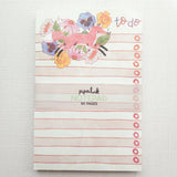 In a quiet clearing of Wildflower Woods, a fox moves through blooming flowers, petals lifting gently as he passes beneath open sky. This notepad brings that playful, woodland moment to your desk, making everyday lists feel a little more inviting.

Designed to be practical without feeling busy, this notepad offers a simple, cheerful way to keep track of daily to-do lists and planning.