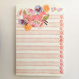 In a quiet clearing of Wildflower Woods, a fox moves through blooming flowers, petals lifting gently as he passes beneath open sky. This notepad brings that playful, woodland moment to your desk, making everyday lists feel a little more inviting.

Designed to be practical without feeling busy, this notepad offers a simple, cheerful way to keep track of daily to-do lists and planning.