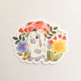 A charming dachshund planter rests among leafy greenery, a thriving cheese plant growing from its back like a small piece of playful décor. This vinyl sticker captures that cozy, plant-filled still life, adding a touch of warmth and whimsy to your everyday essentials.

Made from durable, waterproof vinyl, this sticker is designed to hold up wherever you place it—whether that’s a water bottle, laptop, or journal you reach for daily.