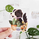 A loyal dog settles in among leafy houseplants, content to rest where sunlight filters softly through the greenery. This vinyl sticker captures that familiar, cozy moment, adding a quiet sense of companionship to your everyday essentials.

Made from durable, waterproof vinyl, this sticker is designed to hold up wherever you place it—whether that’s a water bottle, laptop, or journal you reach for daily.