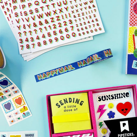 Say it loud, stick it everywhere. This HAPPY MAIL washi tape brings bold rainbow lettering across a rich blue backdrop for instant feel-good vibes on every project. The chunky, layered letters give it that playful, retro pop that stands out on envelopes, journals, planners, and packages. Tearable, repositionable, and easy to love, it’s perfect for sealing up snail mail, adding a colorful edge to pages, or turning any ordinary moment into happy mail-worthy magic.