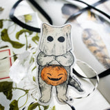 A cat dressed as a ghost for the spooky season, getting ready to go trick or treating! This whimsical illustration blends holiday spirit and magic, making it a perfect sticker for anyone who loves enchanting details. Printed on durable white vinyl, this sticker is waterproof, UV-proof, and made to last — ready to decorate laptops, journals, bottles, and more.