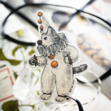 There's a kitty dressed as a clown going around looking for playful adventures. This whimsical illustration blends folklore and magic, making it a perfect sticker for anyone who loves enchanting details. Printed on durable white vinyl, this sticker is waterproof, UV-proof, and made to last — ready to decorate laptops, journals, bottles, and more.