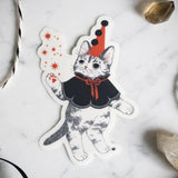 Unlock your inner magician with our Mystical Cat Magician Vinyl Sticker. This captivating sticker showcases a spellbinding feline conjuring sparkling stars and enchantment from the cosmic abyss. It's a symbol of the limitless enchantment that lies within you. Apply this sticker to any surface - it adheres effortlessly to your laptop, journal, water bottle, and more.