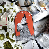 Unleash the magic with our Wizard Vinyl Sticker. This enchanting sticker features a mystical feline wizard, carefully holding a mysterious egg, poised for the moment of transformation. Apply this sticker to any surface, from your laptop to your notebook, and watch the enchantment unfold. Its white background complements any backdrop. Crafted from durable white glossy vinyl, this sticker will remain vivid and intact for a long time.