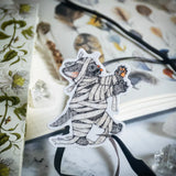 This cute little kitty has morphed into a walking zombie on the hunt. Illustrated in a whimsical pen-and-ink style with a soft vintage touch, “Zombie Kitty” brings a spooky charm and a smile wherever it goes. Printed on durable white vinyl, this sticker is waterproof, UV-proof, and long-lasting — perfect for decorating water bottles, laptops, journals, or anywhere a touch of magic is needed.