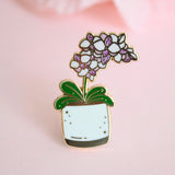 Pin de esmalte con maceta de orquídeas