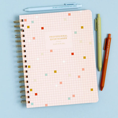 Stay organized and inspired with the Professional Overthinker Spiral Notebook! Featuring lined pages for all your thoughts, lists, and brainstorms, this 7” x 9” wire-bound notebook is perfect for journaling, note-taking, or planning your next big idea. The playful cover design makes it a great desk companion or a fun gift for students, writers, teachers, or anyone who loves to jot things down. Whether you’re tackling to-do lists or letting your creativity flow, this stylish and functional notebook is here t