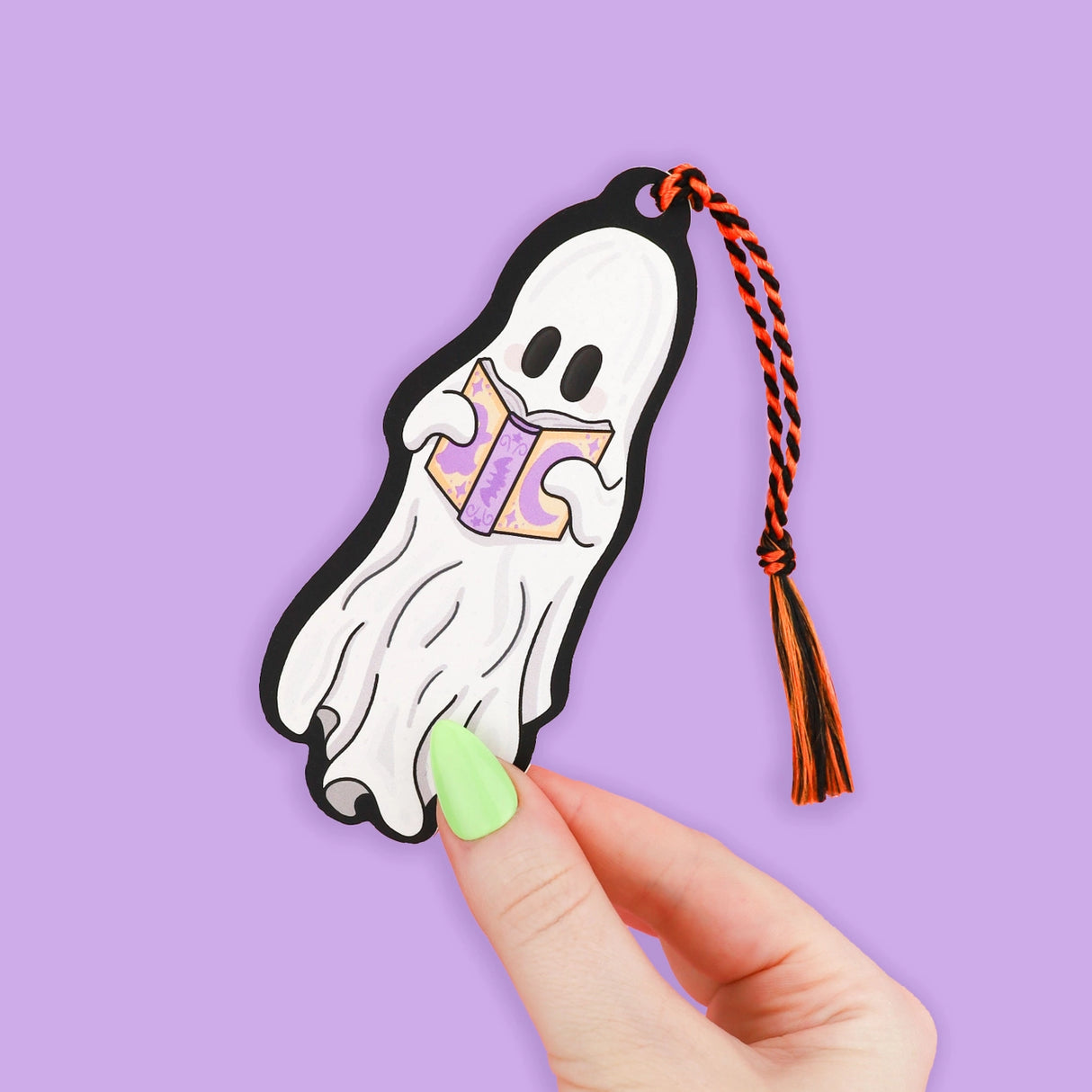 Reading Ghost' Bookmark by Turtle's Soup. Hold your spot in style with our fun and funky bookmark collection! Whether you prefer romance, fantasy, or science fiction, our bookmarks will fit perfectly between the pages of your favorite novel.

🐢 Includes orange and black tassel

🐢 Bookmark is printed on sustainably-sourced premium ultra-thick card stock with soft-touch matte texture

🐢 Unique design on the front and back

🐢 Bookmark measures 2" x 6"

🐢 Copyright © 2024 Turtle's Soup. All Rights Reserved