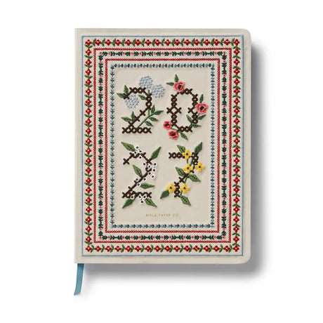 A daily essential with keepsake quality. With a cover inspired by classic cross stitch samplers, this fabric-wrapped planner features gold foil details, weekly and monthly views, space for notes and to-dos, and a list of celebrations.&nbsp;

DETAILS

Printed in full color with foil stamped year
Book cloth cover with ivory uncoated paper
Natural white text paper interior
January 2027-December 2027
Monthly and weekly views
Space for notes each week
List of celebrations
7.18" W x 9.62" L