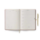 Spanning January 2027 to December 2027, this hardcover planner is framed in our charming Paisley print with a foil-stamped year, and an elastic closure. In addition to weekly and monthly views, the interior includes space for weekly notes and to-dos, a list of celebrations, a pocket folder for storage, and a gold pen.

DETAILS

Printed in full color with foil stamped year
Book cloth wrapped hardboard cover
January 2027-December 2027
Monthly and weekly views
Space for notes and to-dos each week
List of celeb