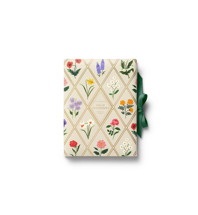 A prettier stationery stash, perfect for writing on the go. Printed with Garden Study florals in six individual designs, this folio-style set includes 12 notecards (two of each design) with matching envelopes, tucked inside a coordinating folder with a ribbon-tie closure.