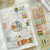 Slow down, get cozy, and lose yourself in a good book with Take Time To Read Pre-cut PET Tape 3.0 — a warm and nostalgic collection made for book lovers and journaling enthusiasts.

This tape features beautiful bookshelves, stacks of novels, cozy reading corners, teacups, lamps, plants, and charming literary details in rich vintage tones. Every piece is designed to create comforting, story-filled spreads that celebrate the joy of reading and quiet moments.

Because the designs are pre-cut, each piece works 