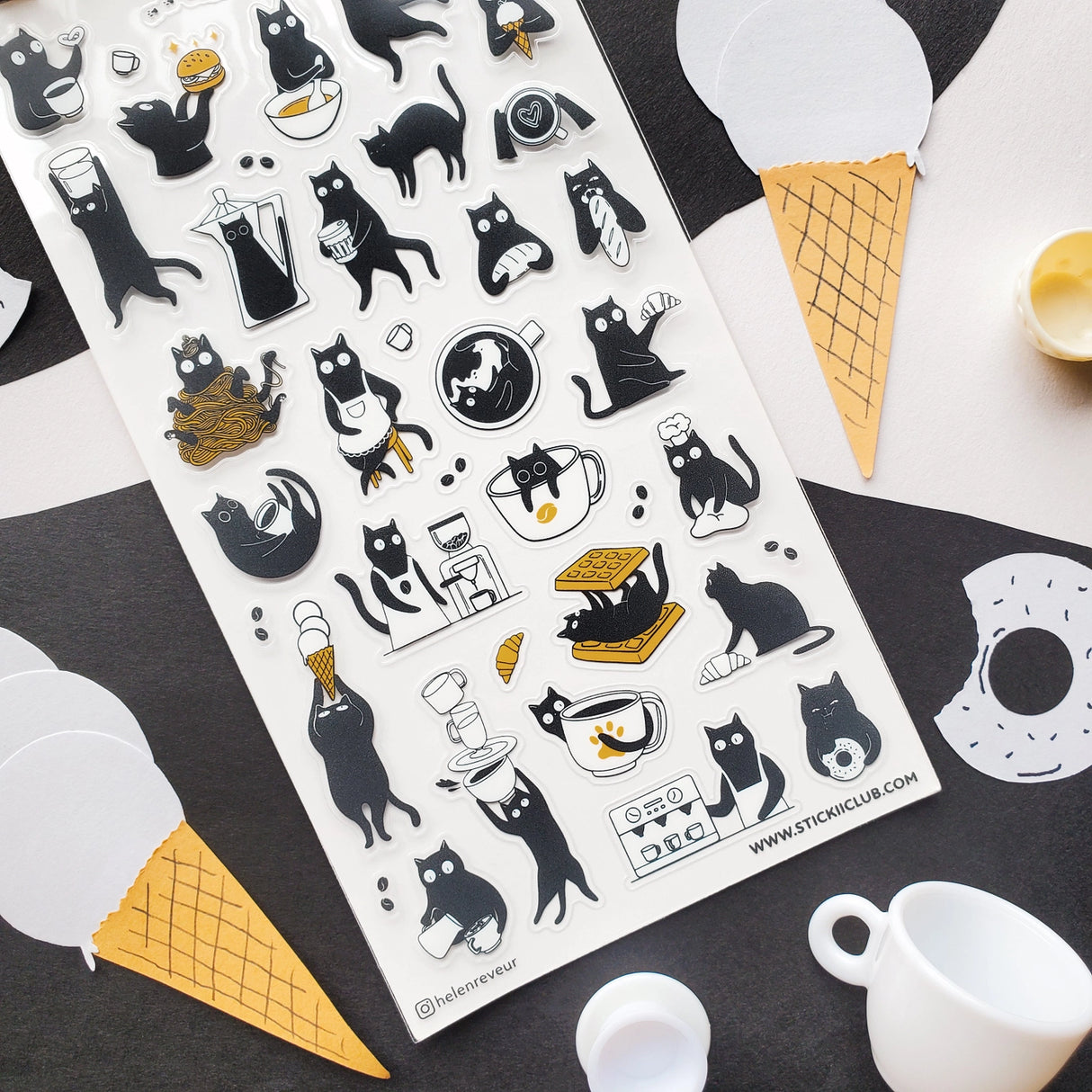 ☕🐈 Chaos is brewing at this tiny cat café! These busy little beans are pouring coffee, stacking waffles, slurping noodles, and sneaking bites between orders. From barista duties to snack-time shenanigans, every kitty is hard at work (or hardly working). Add these mischievous café cats to your pages for a sprinkle of cozy chaos and extra espresso energy.

Top Coating: None
Adhesive Layer: PVC (plastic)
Backing Layer: Clear PET
6.69" x 3.54".
Weight - 0.03lbs.
1 sheet included &nbsp; &nbsp;