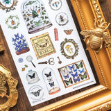 🦋🔍 Explore an enchanting cabinet of wonders with @nussay_art’s mesmerizing entomology collection. Jewel-toned beetles, delicate butterflies, and mysterious moths rest beneath glass domes and within ornate vintage frames, like tiny treasures on display to bring to life the magic of old naturalists and their treasured discoveries.