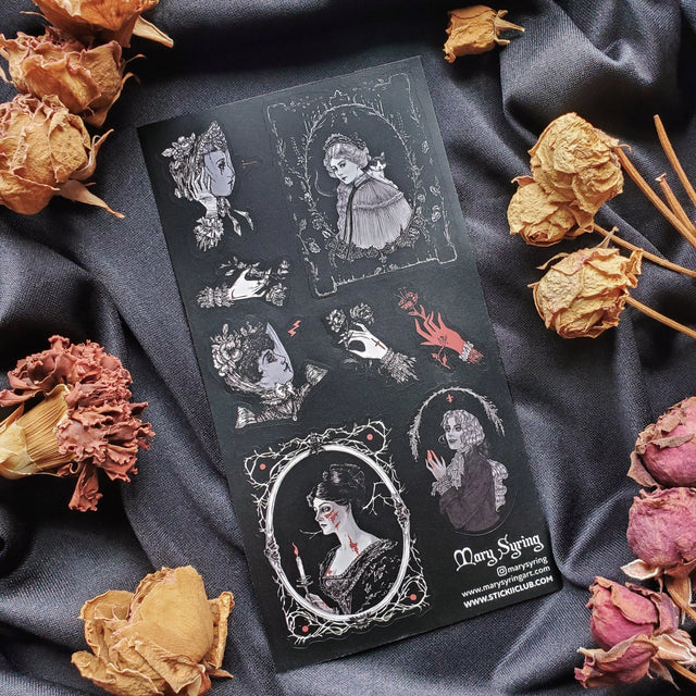 🌹🩸 Draped in shadows and mystery, @marysyring’s hauntingly beautiful figures emerge from candlelit portraits and thorn-laced frames. With ghostly gazes, and a touch of Victorian elegance, these vampiric ladies prove that love never fades with time. Each portrait murmurs of Morticia levels of romance.