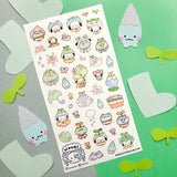 💧🌱 Spring is here, and a sprinkle of rain has brought @wooqiart’s kawaii garden to life! Cuties in froggy hoods and sprouty hats step out to enjoy the season among happy garden friends. With pastel raindrops, leafy umbrellas, and fresh flowers, we wish every drizzly day could be this adorable!
