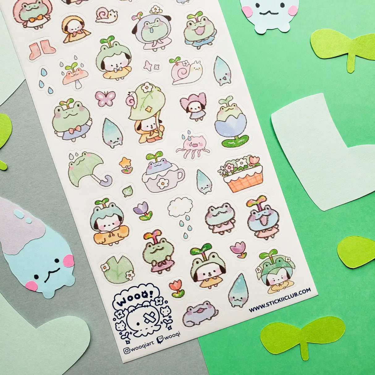 💧🌱 Spring is here, and a sprinkle of rain has brought @wooqiart’s kawaii garden to life! Cuties in froggy hoods and sprouty hats step out to enjoy the season among happy garden friends. With pastel raindrops, leafy umbrellas, and fresh flowers, we wish every drizzly day could be this adorable!