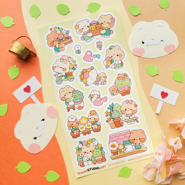 🐻💐 Step into @shandstudio’s blooming bear garden, where flower-loving friends spend their days planting seeds, watering blossoms, and sharing the prettiest petals around! From building cheerful bouquets to caring for potted plants and spreading joy one bloom at a time, this sheet will fill your pages with nonstop sunshine and smiles!

Art by: @shandstudio

Top Coating: None
Adhesive Layer: Paper
Backing Layer: Clear PET
6.69" x 3.54".
Weight - 0.03lbs.
1 sheet included