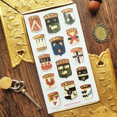 Step into the grand halls of ancient kingdoms with this striking collection of heraldic crests. From star-studded banners and geometric sigils to proud animal emblems symbolizing strength, loyalty, and courage, each shield carries the spirit of medieval artistry and old-world craftsmanship.

Top Coating: None
Adhesive Layer: Paper&nbsp;
Backing Layer: Clear PET
Size: 6.69" x 3.54"
1 sheet included
