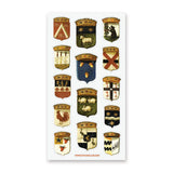 Step into the grand halls of ancient kingdoms with this striking collection of heraldic crests. From star-studded banners and geometric sigils to proud animal emblems symbolizing strength, loyalty, and courage, each shield carries the spirit of medieval artistry and old-world craftsmanship.

Top Coating: None
Adhesive Layer: Paper&nbsp;
Backing Layer: Clear PET
Size: 6.69" x 3.54"
1 sheet included