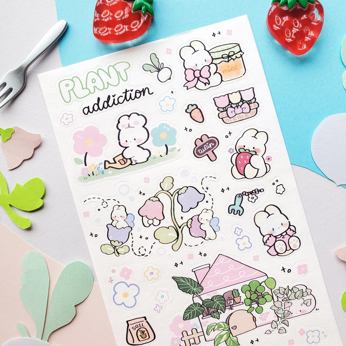 🌱🐰 In @memiartt’s cozy little plant paradise, bunny gardeners nurture with love, muddy paws, and lots of happy hops! From cuddling flowers and mixing soil to watering sprouts, potting leafy friends, and sneaking carrot snack breaks, these bunnies are always busy growing something wonderful that makes this sheet burst with garden magic!

Art by: @memiartt

Top Coating: None
Adhesive Layer: Paper
Backing Layer: Paper
6.69" x 3.54".
Weight - 0.03lbs.
1 sheet included 