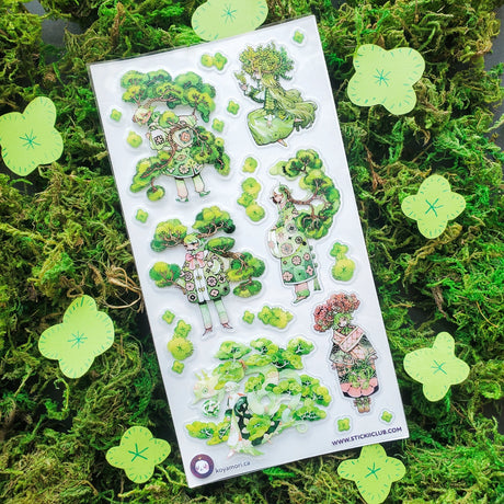 🌳🍃 Get ready to branch out with @maruti_bitamin’s bonsai beauties and leafy legends! These stylish forest guardians rock living tree crowns, flowing robes, and nature magic like it’s the hottest green trend of the season. Rooted in charm and bursting with botanical flair, this set is ready to sprout some serious wow on your pages!

Art by: @maruti_bitamin

Top Coating: None
Adhesive Layer: PVC (plastic)
Backing Layer: Clear PET
6.69" x 3.54".
Weight - 0.03lbs.
1 sheet included &nbsp; &nbsp;