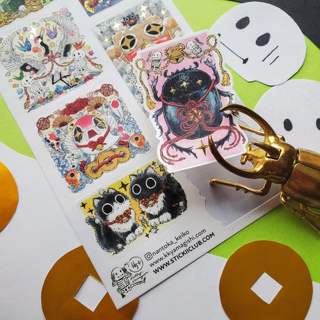 🪙🐸 Luck meets mischief in this enchanting sheet by @nantoka_keiko. In this wild festival of fortune: coin-loving frogs, dancing skeletons, and quirky spirit creatures stack coins, ring bells, and summon good vibes in the most unexpected ways. Stick them anywhere you need a boost of magic, sparkle, and playful fortune!

Art by: @nantoka_keiko