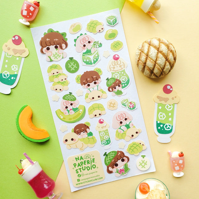 🍈🧃 Craving something delish and refreshing? From bubbly drinks to fluffy buns, look no further than @nao.paperie’s kawaii crew. Packed with fizzy melon sodas, turtle-shaped melonpan, honeydew slices, and the sweetest melon-loving friends.

Art by: @nao.paperie

Top Coating: None
Adhesive Layer: Paper
Backing Layer: Clear PET
6.69" x 3.54".
Weight - 0.03lbs.
1 sheet included&nbsp;