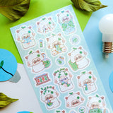 STICKII Science Sheep Sticker Sheet Sheet of cute animal-themed stickers on a colorful background with leaves and a light bulb.