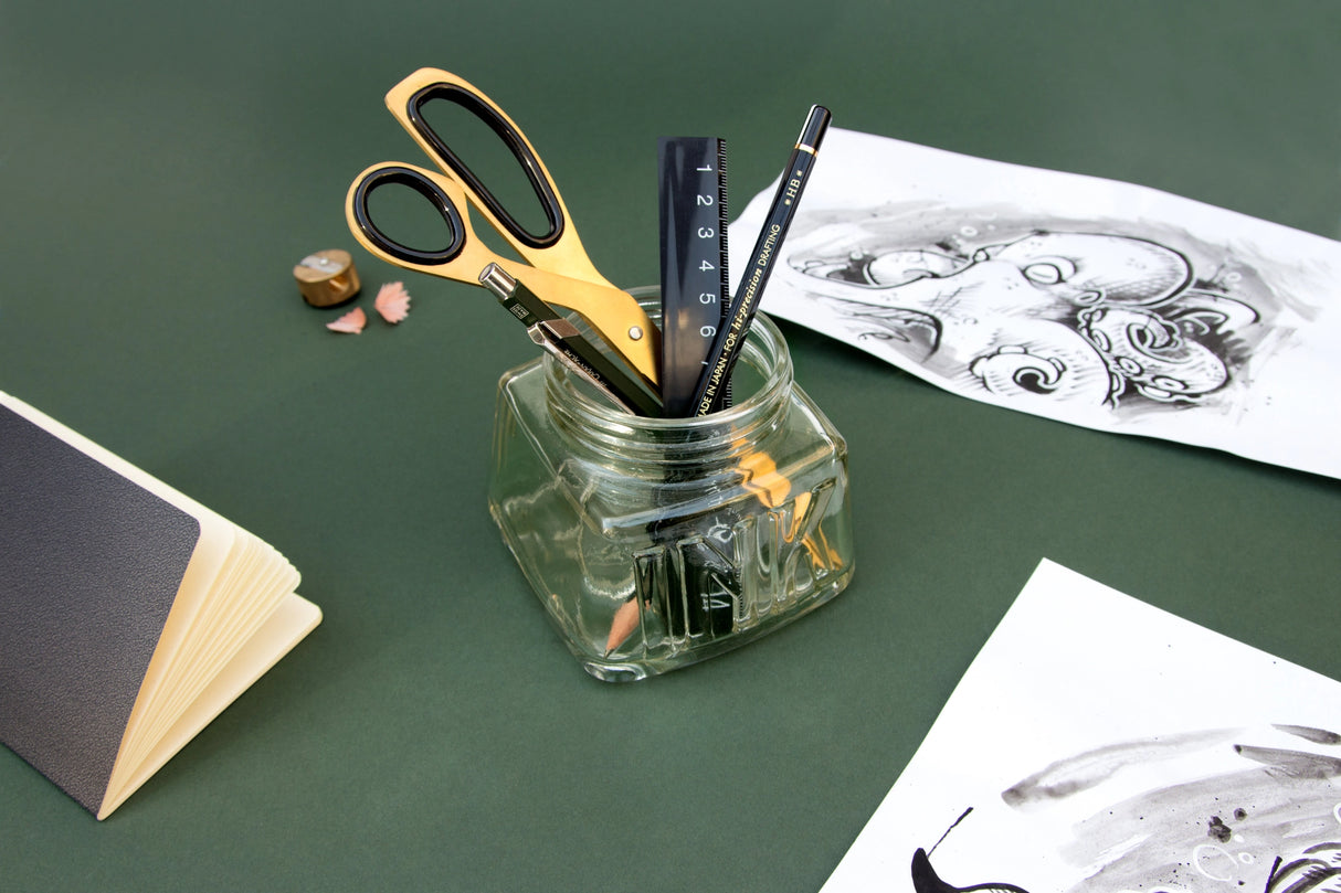 An oversized pen pot designed in the style of a classic inkwell. Made from green-tinted soda glass with plenty of space for your writing tools.

Classic glass pencil pot.
Green tinted soda glass.
Organize your writing tools.
Modern take on a timeless classic.
Pretend you are a Victorian scholar.
Plastic free product and packaging