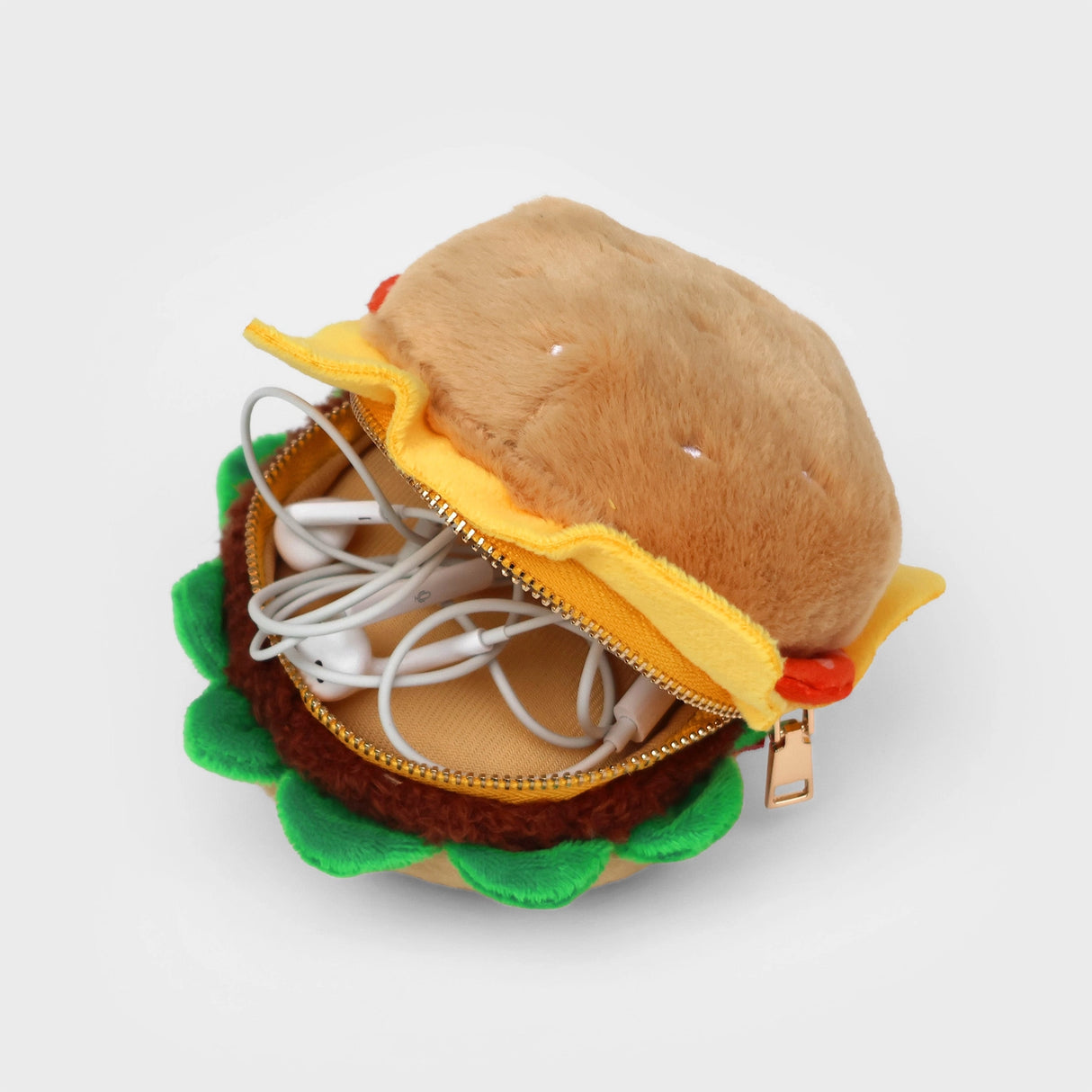 SUCK UK Plush Pouch - Hamburger

Plush burger shaped case with gold zip. Store your belongings amongst the salad and the melted cheese. Yum!

Juicy, tasty, sweet and sour. And very cute. Stuff your stuff into something soft, and squishy. Delicious looking plush zip pouches look like foodie treats but instead of calories, they hold your everyday essentials. From cheesy slices to sickly treats, each pouch is designed to be irresistible and practical. Perfect for pens, cables, cosmetics, or whatever bits and b