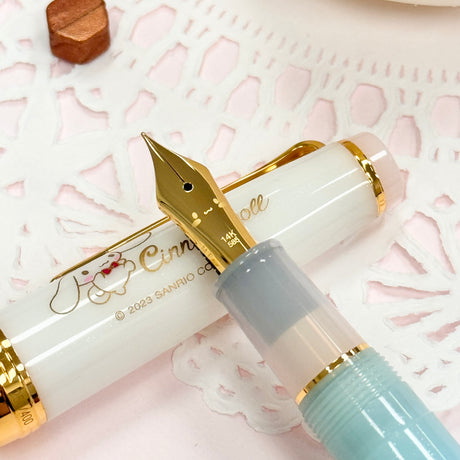Sailor&nbsp;Limited Edition Professional Gear Slim Fountain Pen - Cinnamoroll

Discover a charming collaboration between Sailor Fountain Pen and Sanrio’s beloved character, Cinnamoroll! This limited-edition fountain pen captures the elegant and adorable world of Cinnamoroll, featuring luxurious gold accents on the clip and ring, along with special Cinnamoroll logo motifs on the cap, finial, and nib. The 14k gold nib is beautifully engraved with Cinnamoroll’s face, adding a delightful touch to this unique wr