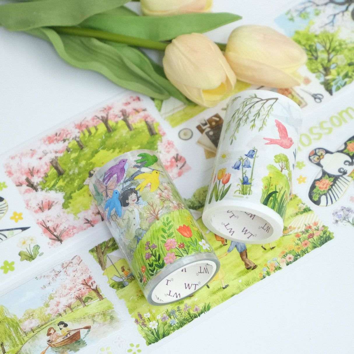 Step into a world where spring never ends. Our Sakura Voyage tape is a panoramic journey through a watercolor dreamland. Featuring hand-painted sceneries of weeping willows swaying in the breeze, vibrant kites dancing in the sky, and soft cherry blossoms in full bloom, every inch tells a story. 

Brand: WT ( The Washi Tape Shop)
Pre-cut Wide Washi/PET Tape
Size: 70mm×5m
Design Loop: 100cm
Material: Washi Tape / PET Clear Tape