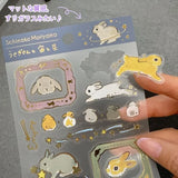A sticker sheet with golden touches featuring rabbits surrounded by a sky full of stars is here to add both adorable and elegant touches to your journal pages