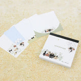 Shinzi Katoh Memo Pad - Uneven Cats Clover Notebook with cat illustrations on a textured surface