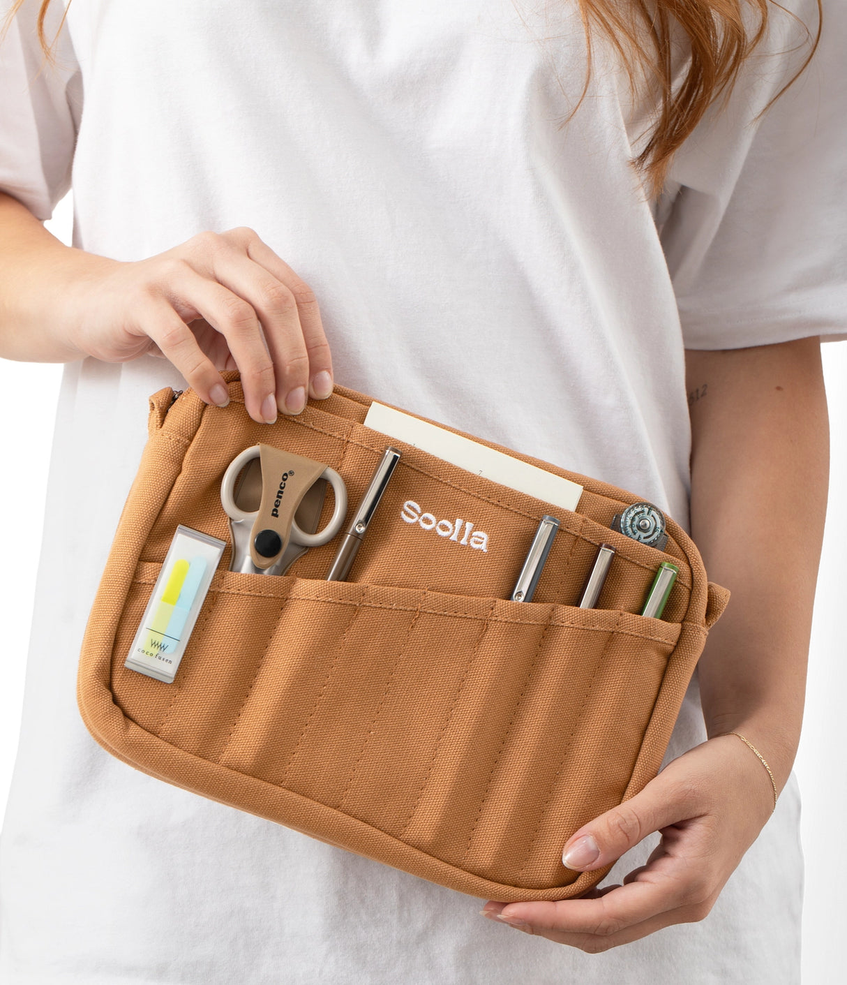Features &amp; Specs

Front layout: 8 slanted pockets + 3 directly behind
Interior: Main compartment fits an A5 notebook; two open compartments on each wall
Back panel: 3 wide exterior pockets + one full-length slip pocket&nbsp;
Quick-drying duck canvas — sturdy, breathable, and machine-washable
Convertible design — hooks for your own strap or a Soolla strap (coming soon)&nbsp;
Structured silhouette — holds its shape even when lightly packed
Full-width YKK zipper — smooth and durable
Compact profile — fits 