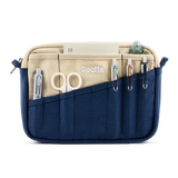 A compact carry-all pouch for artists, makers, and stationary lovers who appreciate a little order in their chaos. Structured enough to hold its form, soft enough to fit anywhere, and fully machine-washable for the days that get a little messy — your tools, pens, and creative essentials stay safe, visible, and ready wherever you go.

Inside, 20 pockets make space for art supplies, stationary essentials, and an A5 notebook, all secured by a smooth YKK zipper. Sized to fit within larger bags or carry on its o