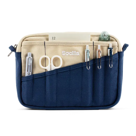 A compact carry-all pouch for artists, makers, and stationary lovers who appreciate a little order in their chaos. Structured enough to hold its form, soft enough to fit anywhere, and fully machine-washable for the days that get a little messy — your tools, pens, and creative essentials stay safe, visible, and ready wherever you go.

Inside, 20 pockets make space for art supplies, stationary essentials, and an A5 notebook, all secured by a smooth YKK zipper. Sized to fit within larger bags or carry on its o