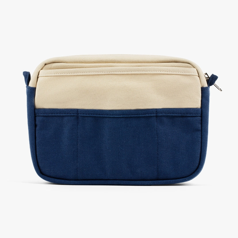 A compact carry-all pouch for artists, makers, and stationary lovers who appreciate a little order in their chaos. Structured enough to hold its form, soft enough to fit anywhere, and fully machine-washable for the days that get a little messy — your tools, pens, and creative essentials stay safe, visible, and ready wherever you go.

Inside, 20 pockets make space for art supplies, stationary essentials, and an A5 notebook, all secured by a smooth YKK zipper. Sized to fit within larger bags or carry on its o