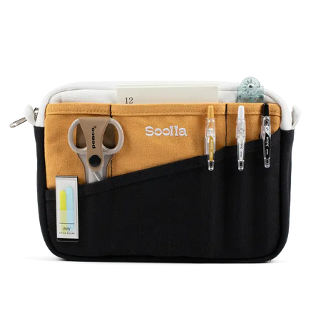 A compact carry-all pouch for artists, makers, and stationary lovers who appreciate a little order in their chaos. Structured enough to hold its form, soft enough to fit anywhere, and fully machine-washable for the days that get a little messy — your tools, pens, and creative essentials stay safe, visible, and ready wherever you go.

Inside, 20 pockets make space for art supplies, stationary essentials, and an A5 notebook, all secured by a smooth YKK zipper. Sized to fit within larger bags or carry on its o