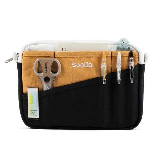 A compact carry-all pouch for artists, makers, and stationary lovers who appreciate a little order in their chaos. Structured enough to hold its form, soft enough to fit anywhere, and fully machine-washable for the days that get a little messy — your tools, pens, and creative essentials stay safe, visible, and ready wherever you go.

Inside, 20 pockets make space for art supplies, stationary essentials, and an A5 notebook, all secured by a smooth YKK zipper. Sized to fit within larger bags or carry on its o