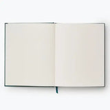 Our embroidered sketchbook is a large, hardcover journal with 108 unlined pages of thick paper perfect for sketching, drawing, and journaling. The cover is wrapped in dark green book cloth and embroidered with our Strawberry Fields florals, and an attached grosgrain ribbon bookmark will save your place