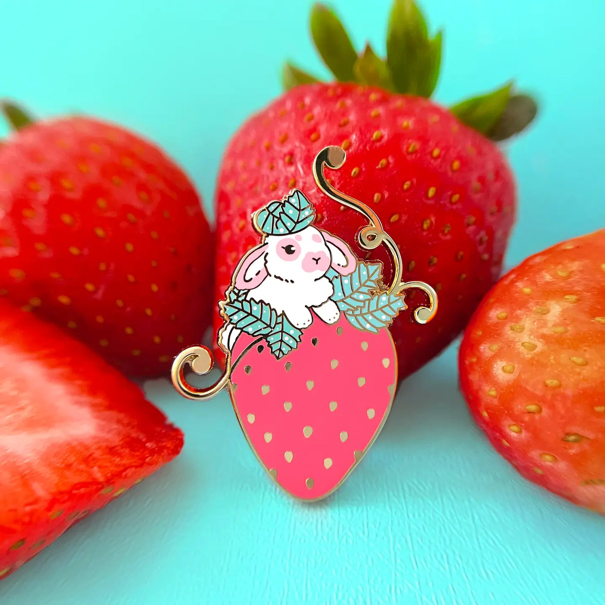 This little bunny is having a blast playing around in a strawberry patch. The perfect strawberry was chosen out of the bunch.

✦ Hard enamel
✦ Shiny gold metal
✦ 1.50 inches
✦ 2 Posts for extra security
✦ Rubber backings
✦ Back stamped for authenticity

Comes packaged on a backing card.