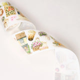 Step into a world where nature and comfort collide. Our Summer Café Wide Tape transforms your stationery into a bustling garden bistro, teeming with life, blooming flowers, and the true owners of the cafe: the cats.

This whimsical design weaves together the architecture of charming coffee shops with the wild beauty of summer florals. Nestled among the potted plants and open doors, you’ll find hand-painted cats exploring, sleeping, and playing.&nbsp;
