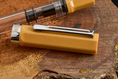 TWSBI ECO Bahama Yellow Fountain Pen

Comes in EF, F, M, B, Stub1.1&nbsp;nib choices
Colors: Yellow/Clear

Pen cap is able to post onto the back of the pen

Piston Filler Fountain pen.
Simply unscrew the end cap, dip into ink, screw back the end cap, and your done! Ready to write!!