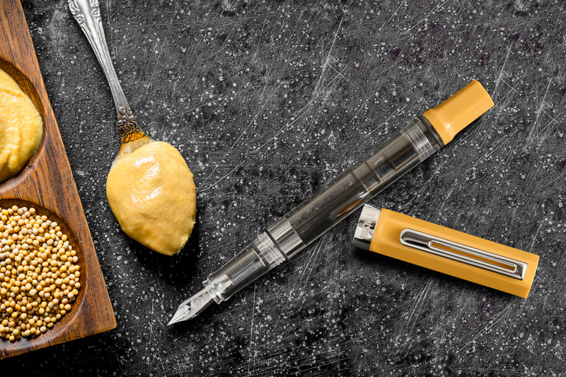 Transparent barrel of the TWSBI ECO Bahama Yellow showing internal piston filling system.