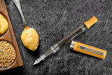 Transparent barrel of the TWSBI ECO Bahama Yellow showing internal piston filling system.